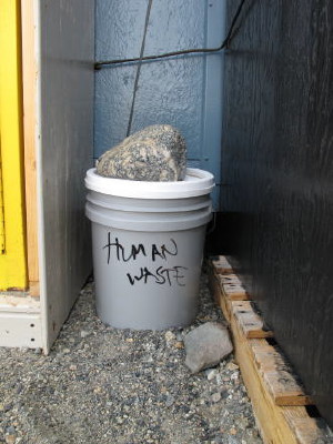 A full bucket of solid human waste sealed, labeled, and put in a place well out of the wind. We do not want this to spill...